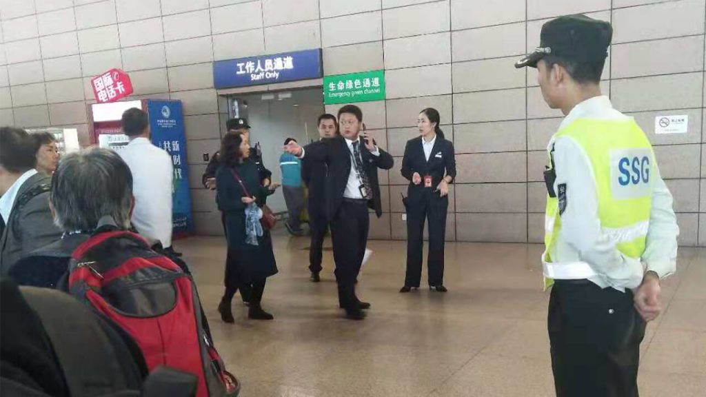 Chinese state security agents stop house-church Christians from boarding a plane in Shanghai to attend a training session in South Korea, Oct. 25, 2018.