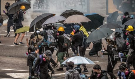 Hong Kong protestors and reporters need face masks and umbrellas to withstand tear gas attacks by the police