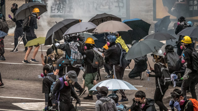 Hong Kong protestors and reporters need face masks and umbrellas to withstand tear gas attacks by the police