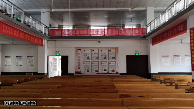 Political propaganda slogans and posters are posted throughout a Three-Self church.
