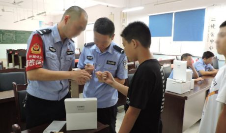 Public security bureau officers in Sichuan’s Shifang city collect middle school students’ DNA samples.