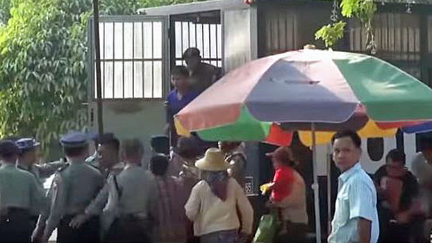 Myanmar police escort the defendants out of a police vehicle for their trial at a courthouse in Patheingyi township, central Myanmar's Mandalay region, March 20, 2020.