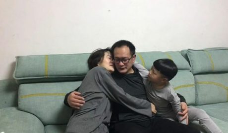 Human rights lawyer Wang Quanzhang (C) embraces his wife Li Wenzu (L) and the couple's young son Wang Guangwei in Beijing in their first family reunion since Wang was released from prison this month after serving five years, April 27, 2020.