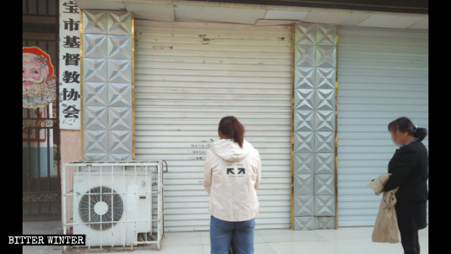 Believers are praying in front of a closed church.