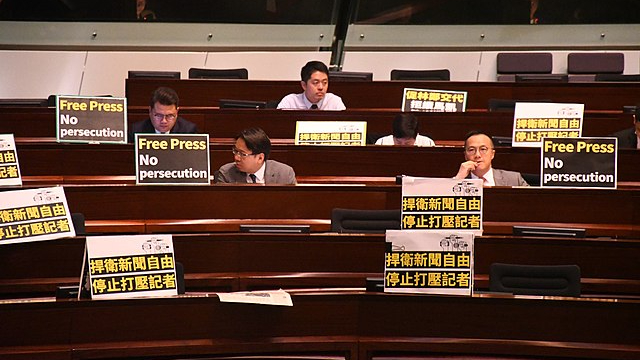 Many Democrats in Hong Kong put protest signs in front of their seats