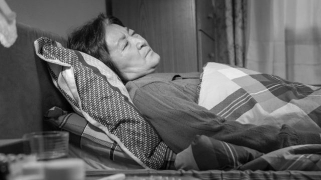 An elderly Christian bed ridden with serious illness