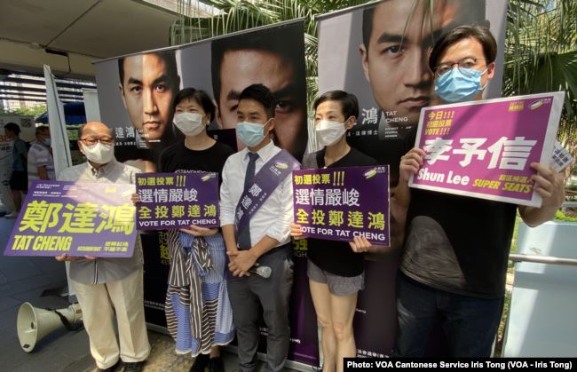 Pro-democracy activists (L-R) Eddie Chu, Gwyneth Ho, Leung Hoi-ching, Tiffany Yuen, Joshua Wong, Sunny Cheung and Lester Shum campaign during primary elections as Hong Kong's pro-democracy parties held weekend primary polls to choose candidates for upcoming legislative elections, July 12, 2020.