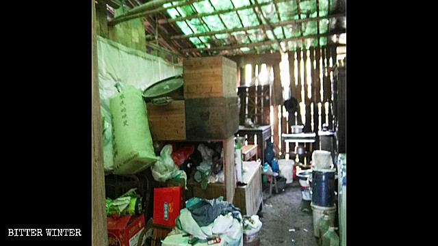 People’s possessions piled in a bamboo shed.