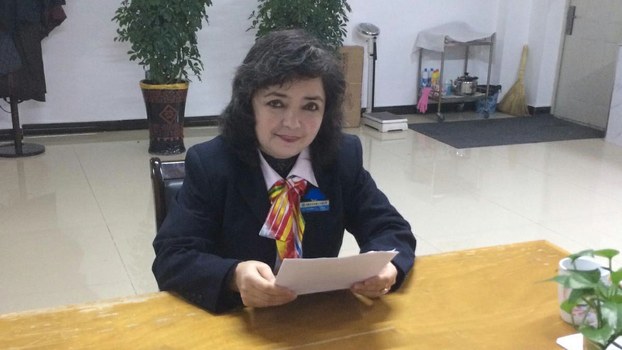 Qelbinur Sidik prepares a lesson in her office in Urumqi, in an undated photo. 