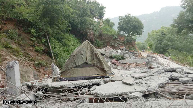 The elderly Taoist lives in a shed after the guest house has been demolished.