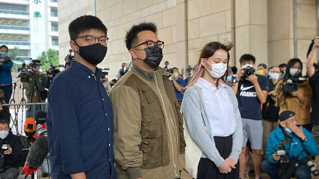 Hong Kong activists, from left, Joshua Wong, Ivan Lam and Agnes Chow arrive at a court in Hong Kong,