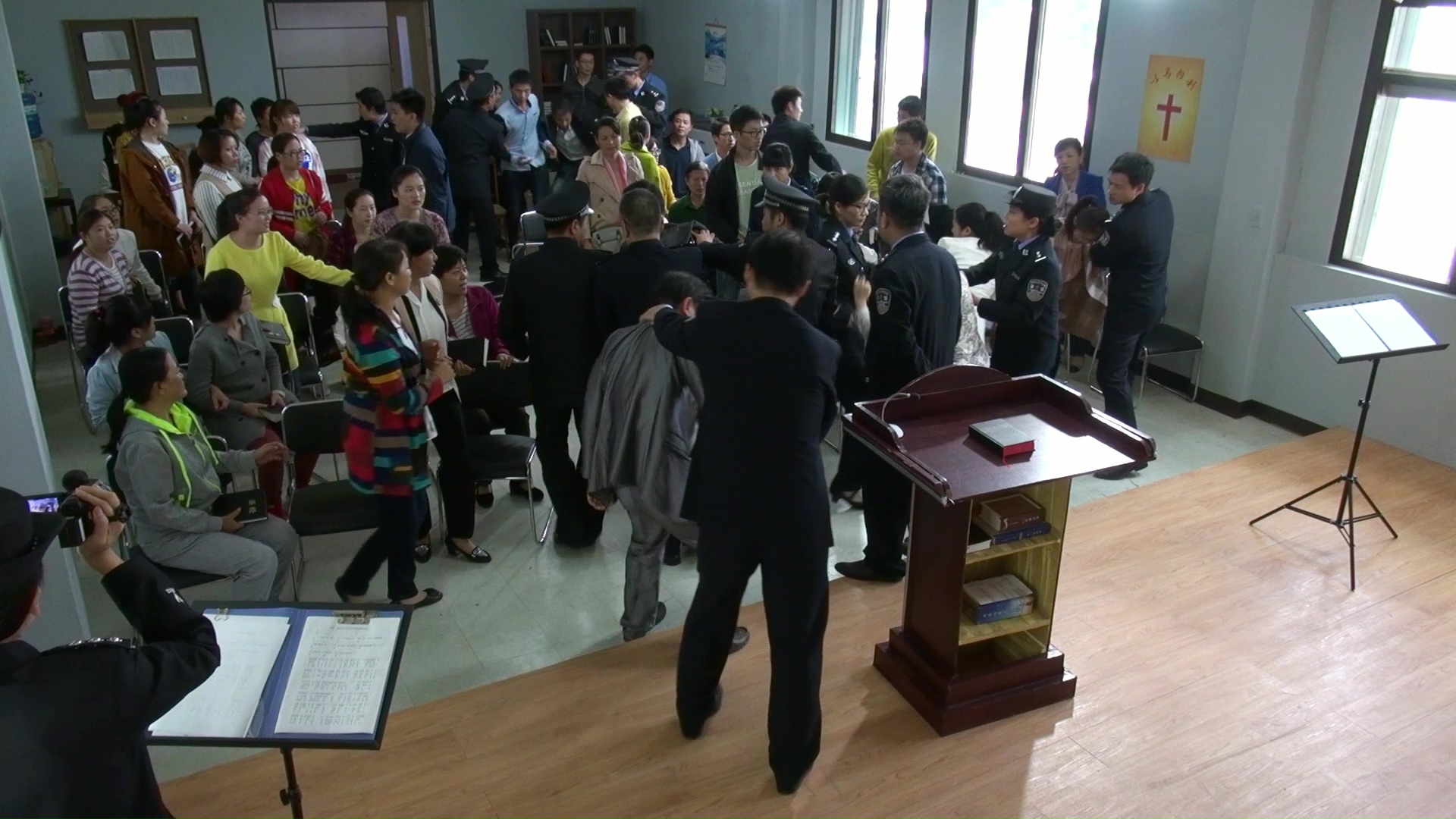 The policemen are arresting Christians during the meeting.